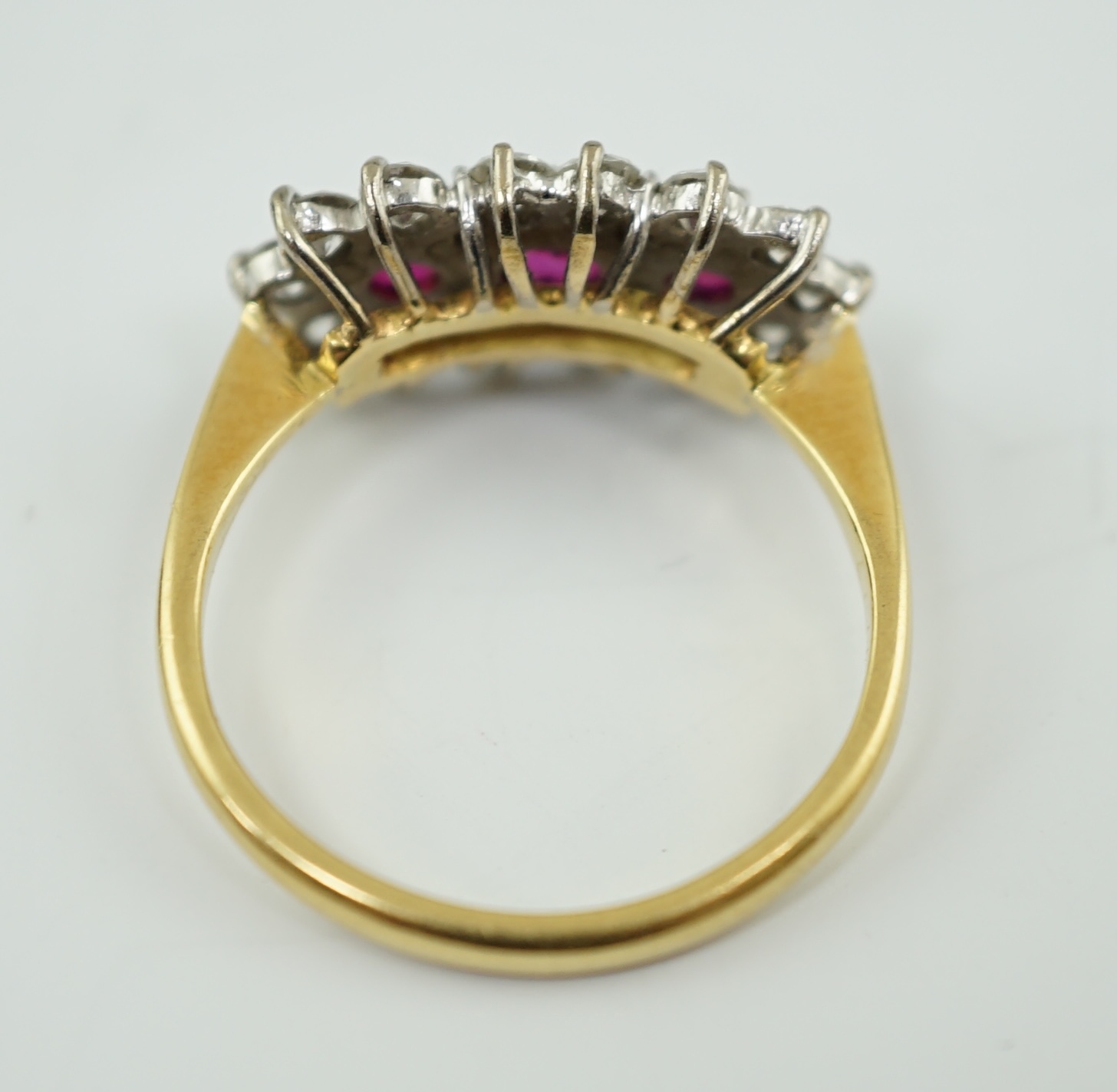 A modern 18ct gold, ruby and diamond set triple cluster ring